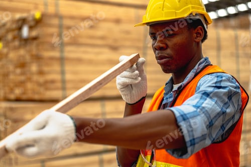 Preview: african man checking the quality of wooden products at workshop
