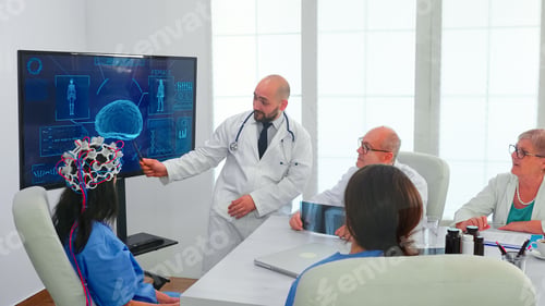 Preview: Female nurse wearing scaning headset for brain activity