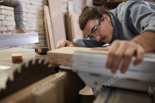 Preview: Carpenter Working with a Table Saw in Workshop