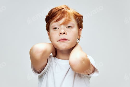 Preview: Red-haired boy funny facial expression white t-shirt isolated background