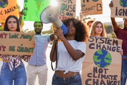 Preview: Group of young multiracial people demonstrate on the city street with climate change banner
