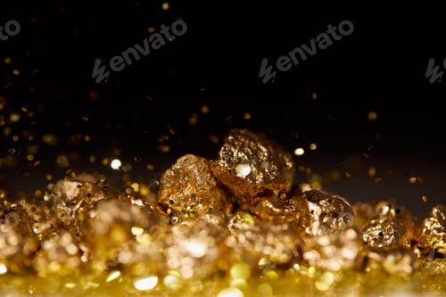Preview: selective focus of golden stones on sparkling surface and black background