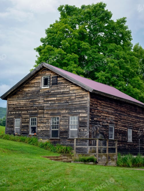 Preview: Rustic barn in a rural setting with weathered wood and a scenic backdrop