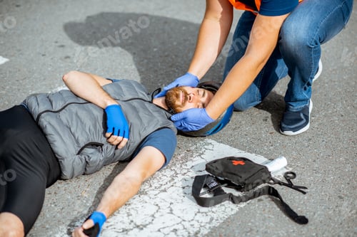 Preview: Road accident with injured cyclist and man providing first aid
