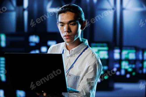 Preview: Engineer in data center with laptop