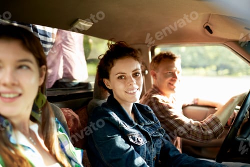 Preview: Three passengers in the cab of a pickup truck, one man and two women.