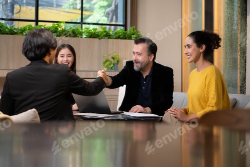 Preview: Businessman and businesswoman discussing a project in the meeting room of co-working space