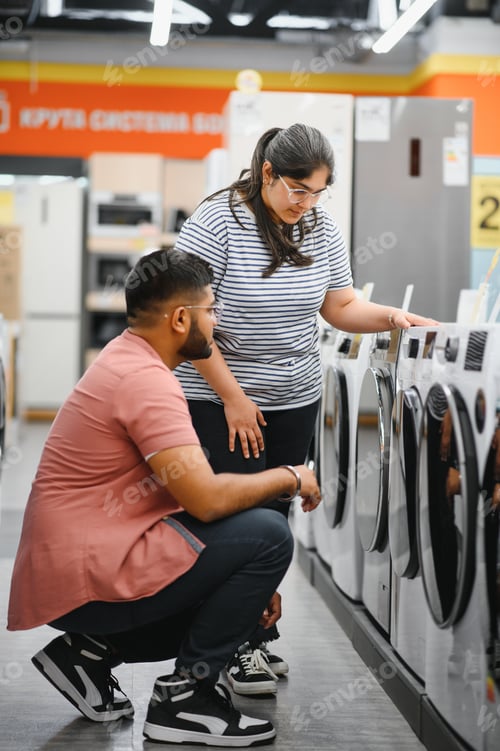 Preview: Indian Couple choosing washing machine at electronics store