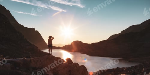 Preview: Adventurous Caucasian Adult Woman Hiking on top of a Canadian Rocky Mountain