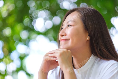 Preview: Portrait image of a young woman relaxing in the garden