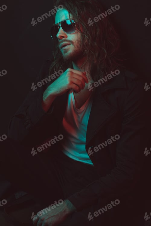 Preview: casual young long haired caucasian man in sunglasses