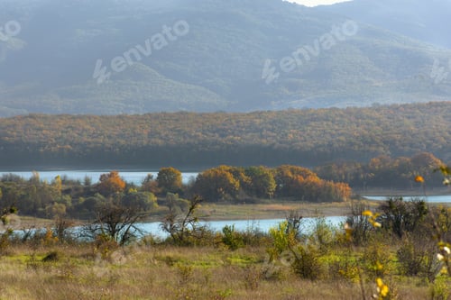 Preview: Autumn mountains forest lake. Golden autumn landscape with a blue lake.
