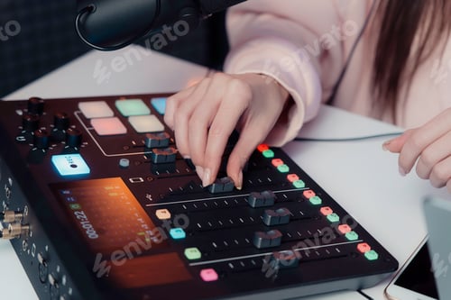 Preview: Podcaster Adjusting Audio Mixer During Live Session
