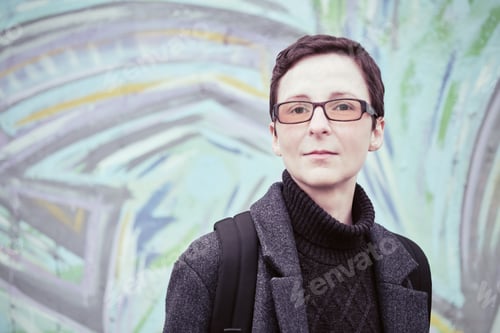 Preview: Portrait of woman in glasses with short haircut. Androgynous appearance, non-binary personality.