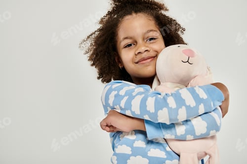 Preview: Tender embrace: young girl affection for stuffed animal