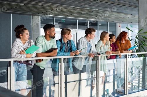 Preview: Group of university students standing indoors, back to school concept