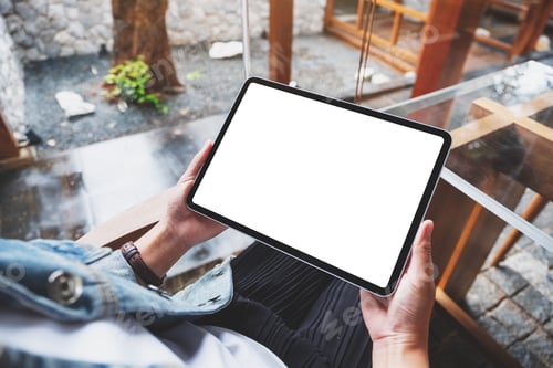 Preview: Mockup image of a woman holding digital tablet with blank white desktop screen in cafe