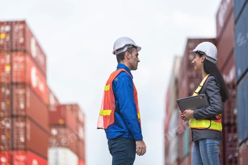 Preview: workers in high visibility safety gear and hard hats discuss operations