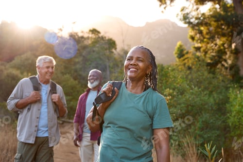 Preview: Group Of Senior Friends Enjoying Hiking Through Countryside Together