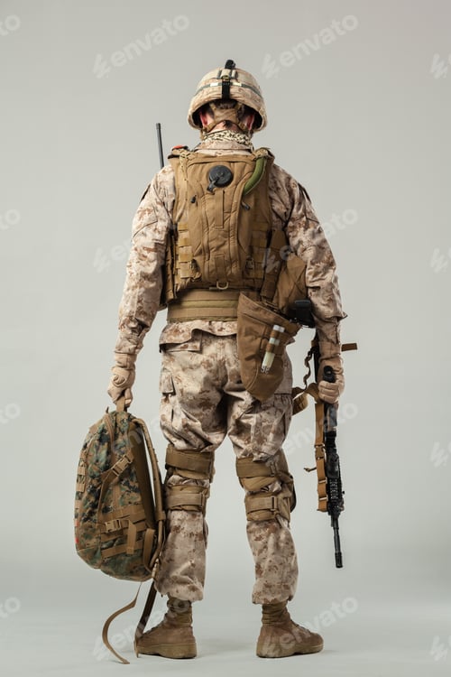 Preview: Soldier stands with gear and weapon in neutral setting during training or mission preparation