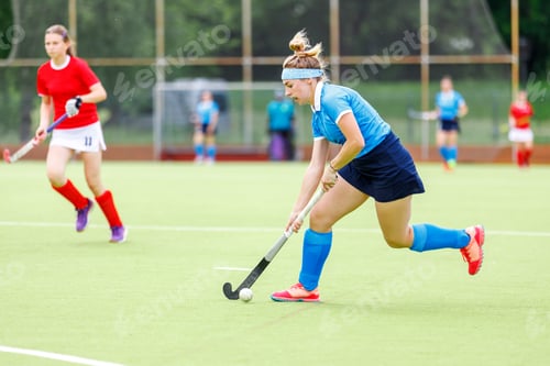 Preview: Young woman field hockey player leading the ball in attack