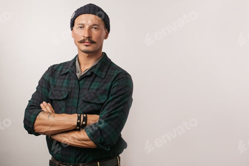 Preview: Man in a Flannel Shirt with Arms Crossed