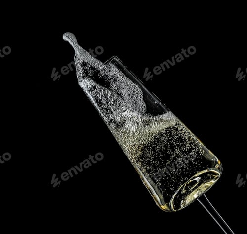 Preview: Glass of champagne on black background. Festive drink