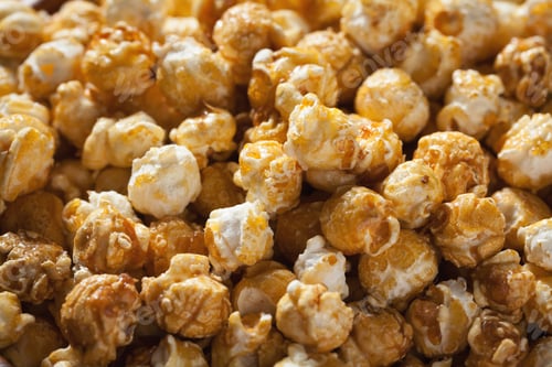 Preview: Golden caramel popcorn closeup. Background of popcorn. Snacks and food for a movie