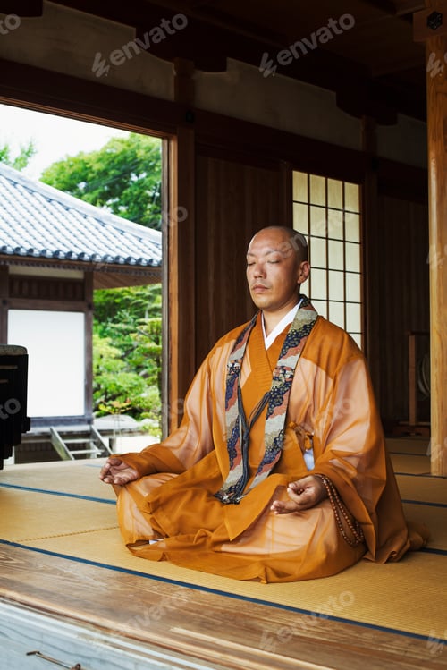Preview: Buddhist monk in a golden robe worshipping