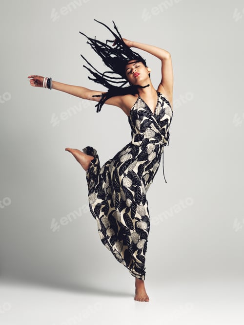 Preview: Freedom is a state of mind. Studio shot of a young woman posing against a grey background.