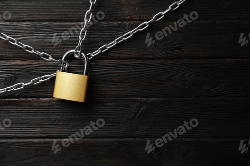 Preview: Steel padlock, chains and space for text on black wooden background, flat lay. Safety concept