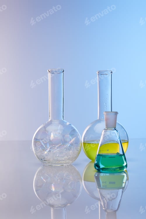 Preview: glass flasks with colorful yellow, blue liquid and bubbles