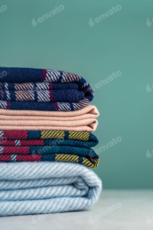 Preview: Stack of woolen checked blankets