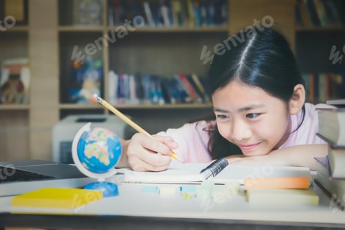 Preview: Education concept. Girl reading and writing in library.