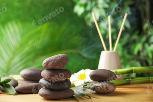 Preview: Composition with stones on table against blurred background. Zen concept