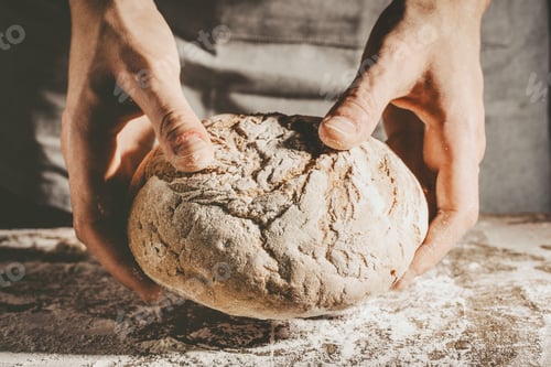 Preview: Baker or chef holding fresh made bread