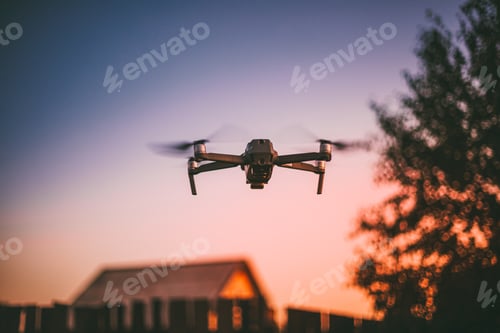 Preview: Flying Electric Drone On Sky At Sunset Sunrise