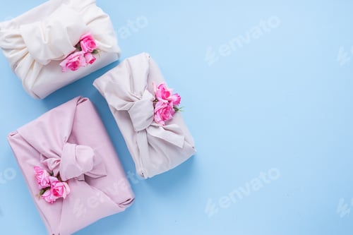 Preview: Holiday gift wrapped fabric manner of Furoshiki blue background. Concept Zero Waste Life.