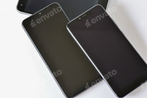 Preview: Top view of black smartphones over the white surface