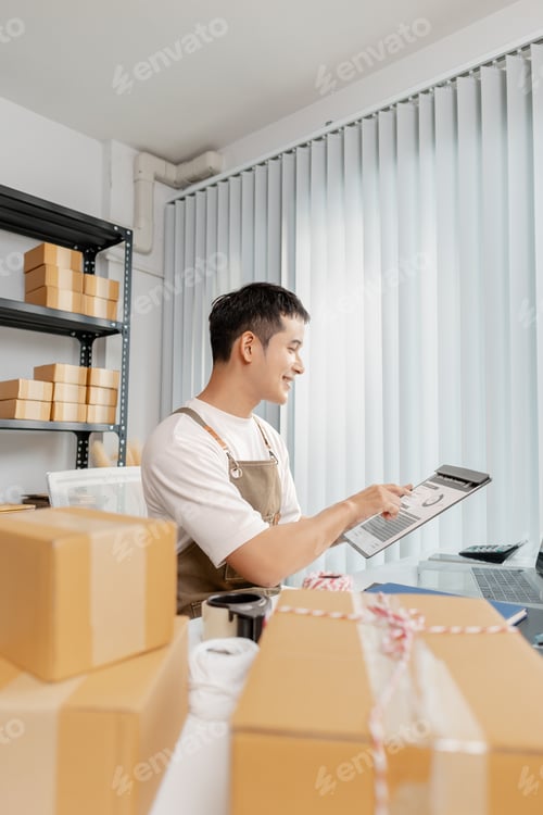 Preview: Young entrepreneur managing online business, preparing packages and working