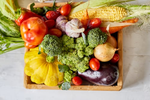 Preview: Wooden box with different fresh farm vegetables on the white background