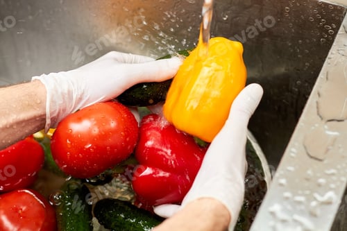 Preview: Vegetables washing under running tap water.