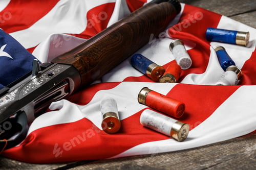 Preview: Automatic rifle on USA flag on wooden background