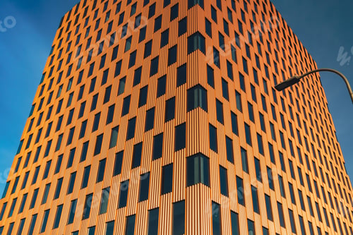 Preview: Modern office building exterior with glass facade on clear sky background. Transparent glass wall of