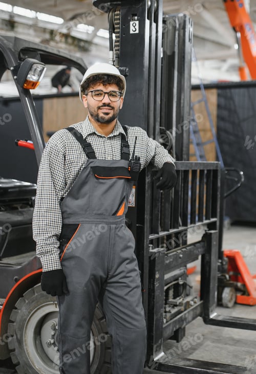 Preview: Arab warehouse worker leaning on forklift in factory