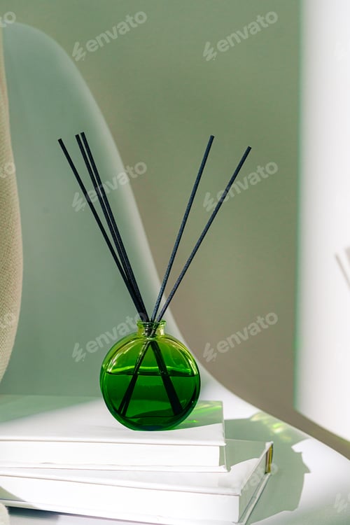 Preview: Liquid home perfume in glass diffuser with sticks on chair