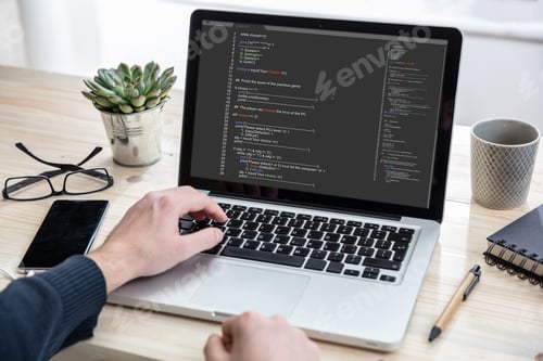Preview: Man programming on a computer, office background