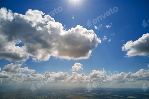 Preview: Aerial view from airplane window at high altitude of earth covered with white puffy cumulus clouds
