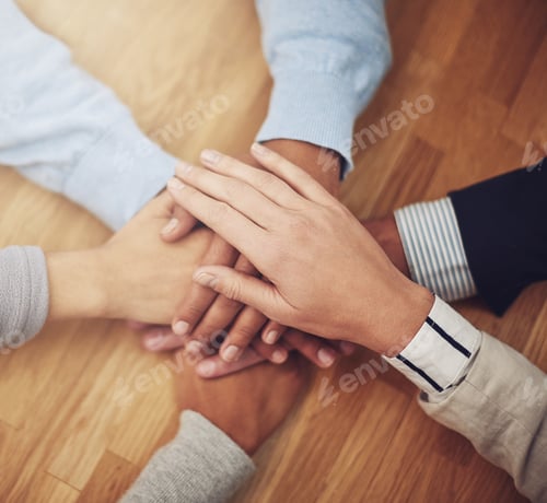 Preview: Cropped shot of a group of businesspeople putting their hands together in unity