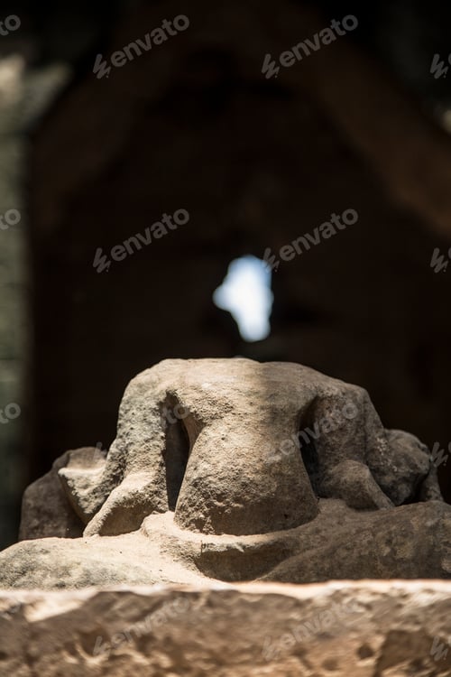 Preview: A stone that with the light of the temple looks like a spirit in Angkor Wat, Cambodia